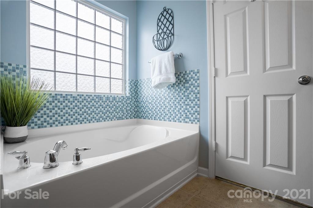 2714 Aldergrove Road Matthews, NC 28105 - Photo 21 of 23 a bathroom with a bathtub and a shower