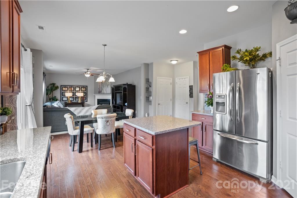 2714 Aldergrove Road Matthews, NC 28105 - Photo 10 of 23 a kitchen with stainless steel appliances a refrigerator a stove a dining table and chairs