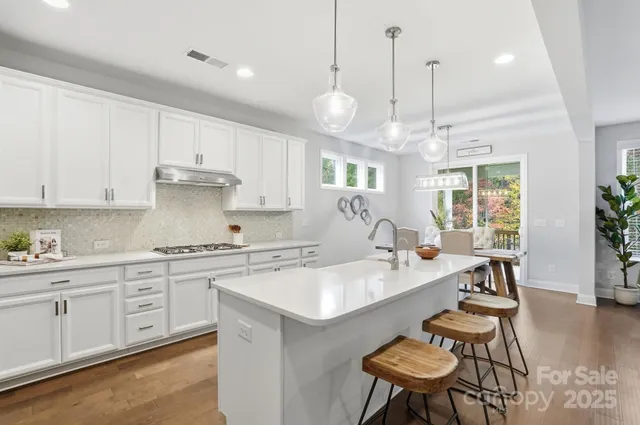 a large white kitchen with a large window