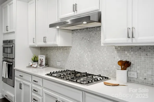 a kitchen with a stove and cabinets