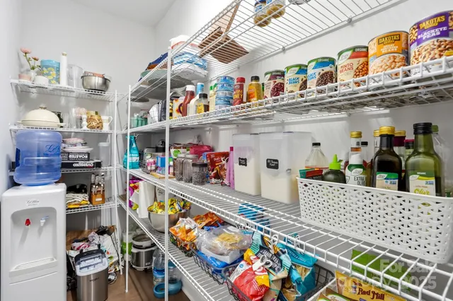 a dining room with furniture a chandelier and wooden floor
