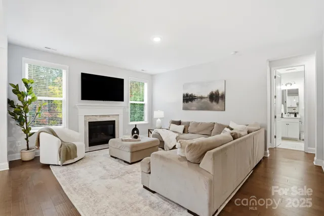 a living room with furniture a fireplace and a flat screen tv