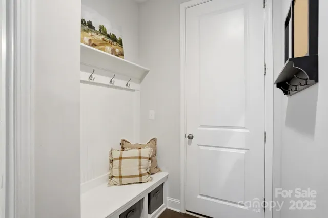 a bedroom with bed and a potted plant