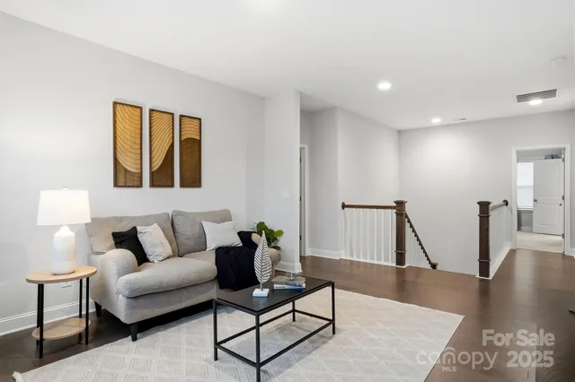 a spacious bedroom with a bed and a chandelier