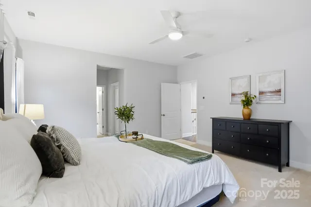 a bedroom with a bed and a potted plant