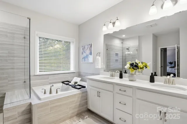 a bathroom with a tub sink and shower