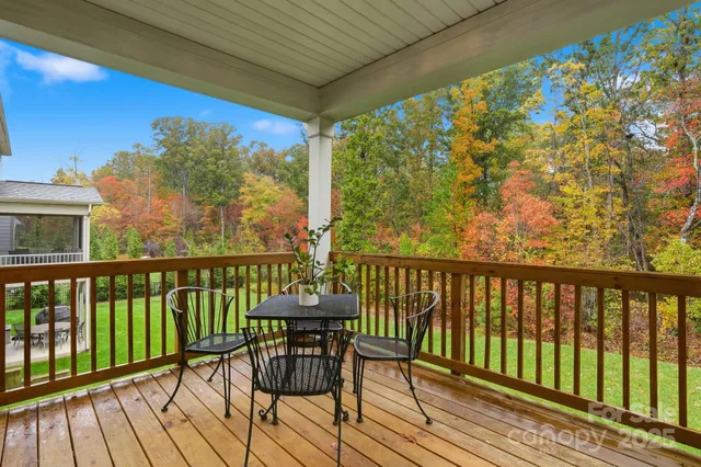 a view of a balcony with chairs and wooden floor