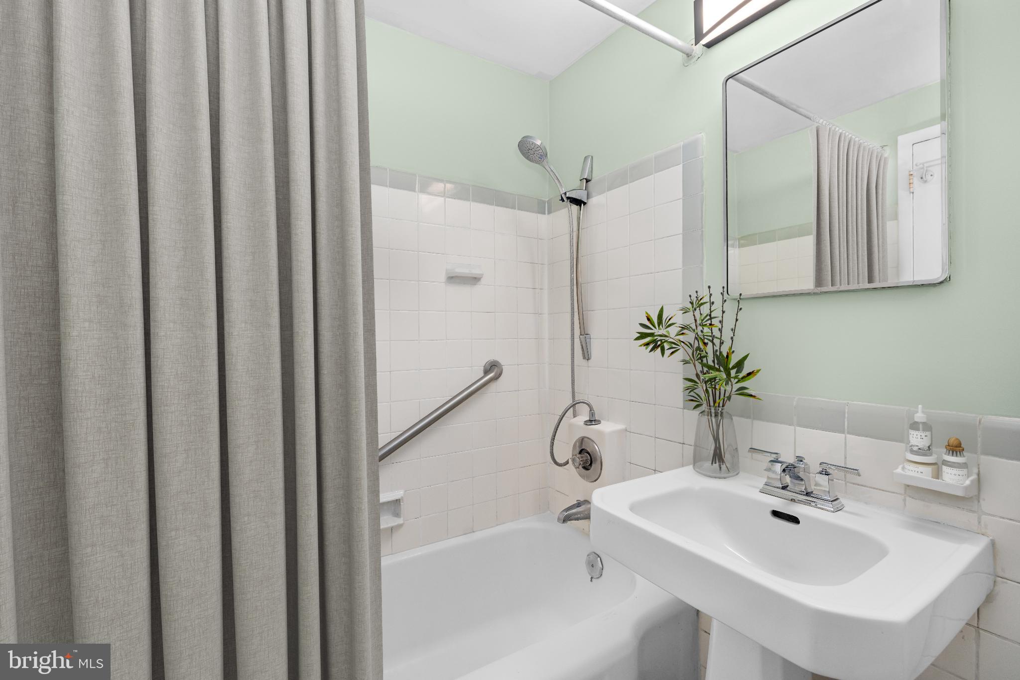 1663 Fitzgerald Lane Alexandria, VA 22302 - Photo 7 of 9 a bathroom with a sink a mirror and a shower