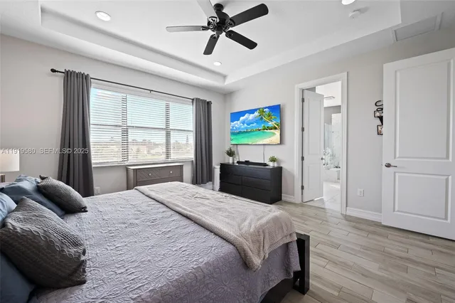 a bedroom with a large bed and a chandelier