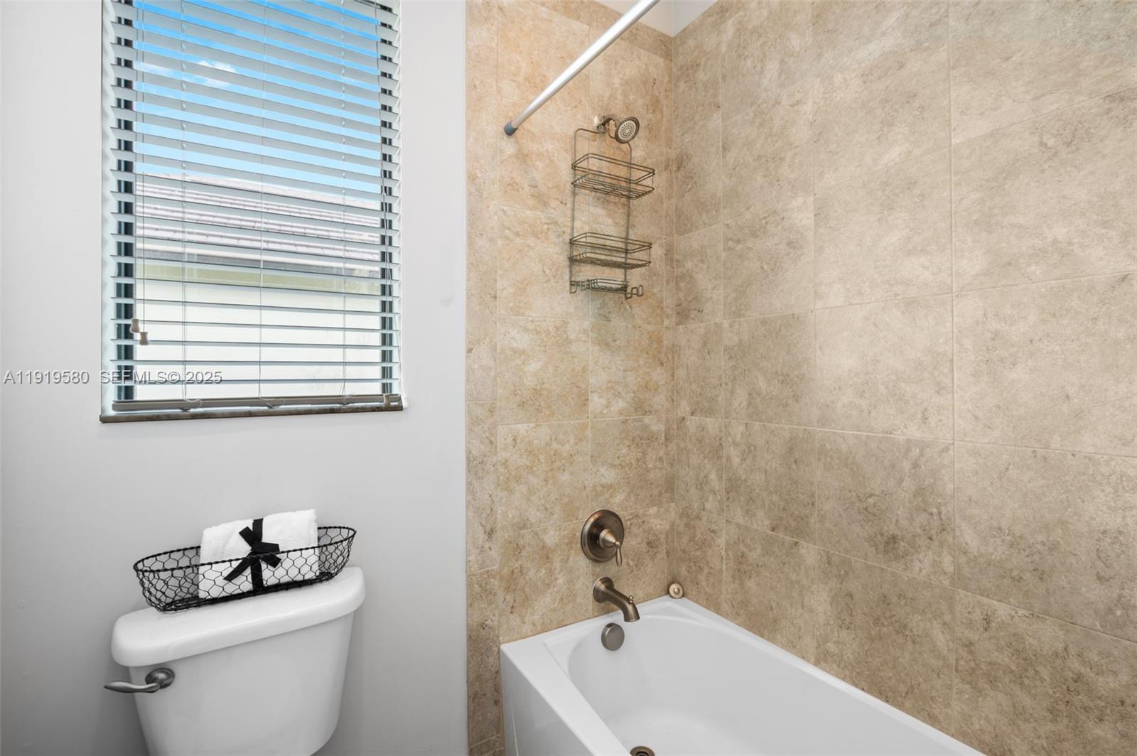 445 Southwest 113th Lane Pembroke Pines, FL 33025 - Photo 17 of 26 a bathroom with a sink a toilet and shower