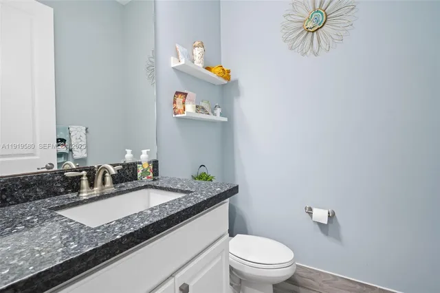 a view of a house with a yard and sitting area