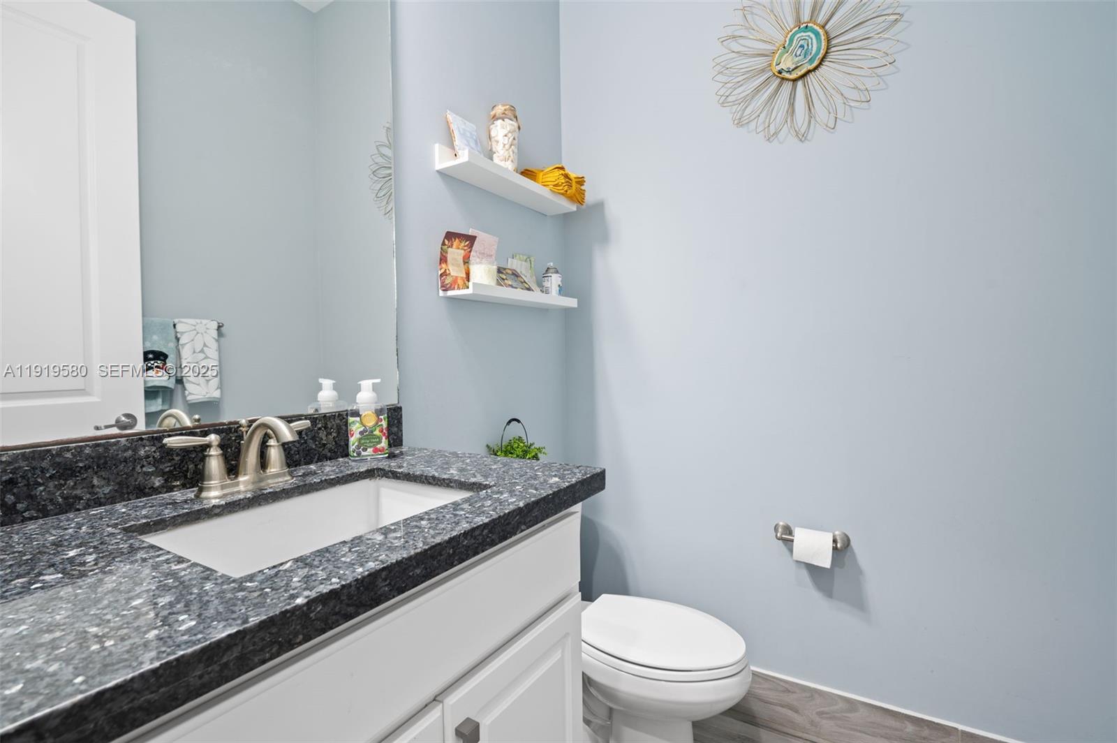 445 Southwest 113th Lane Pembroke Pines, FL 33025 - Photo 19 of 26 a bathroom with a granite countertop sink and a mirror