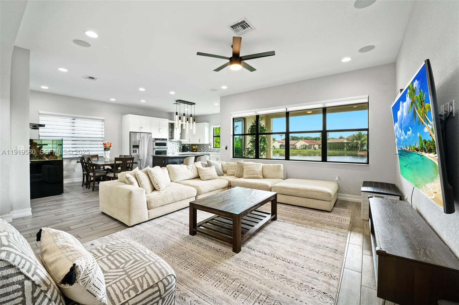 445 Southwest 113th Lane Pembroke Pines, FL 33025 - Photo 4 of 26 a living room with furniture and a flat screen tv