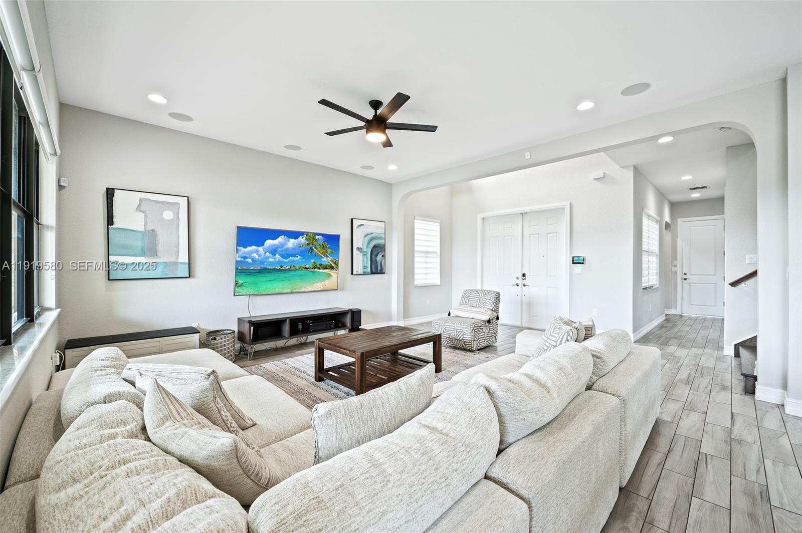 445 Southwest 113th Lane Pembroke Pines, FL 33025 - Photo 5 of 26 a living room with furniture and a flat screen tv