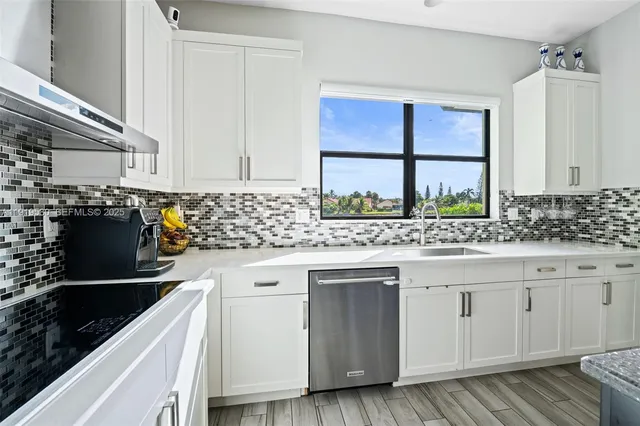 a view of a hallway with wooden floor and entryway