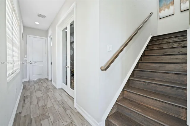 a bedroom with a large bed and a flat tv screen on dresser