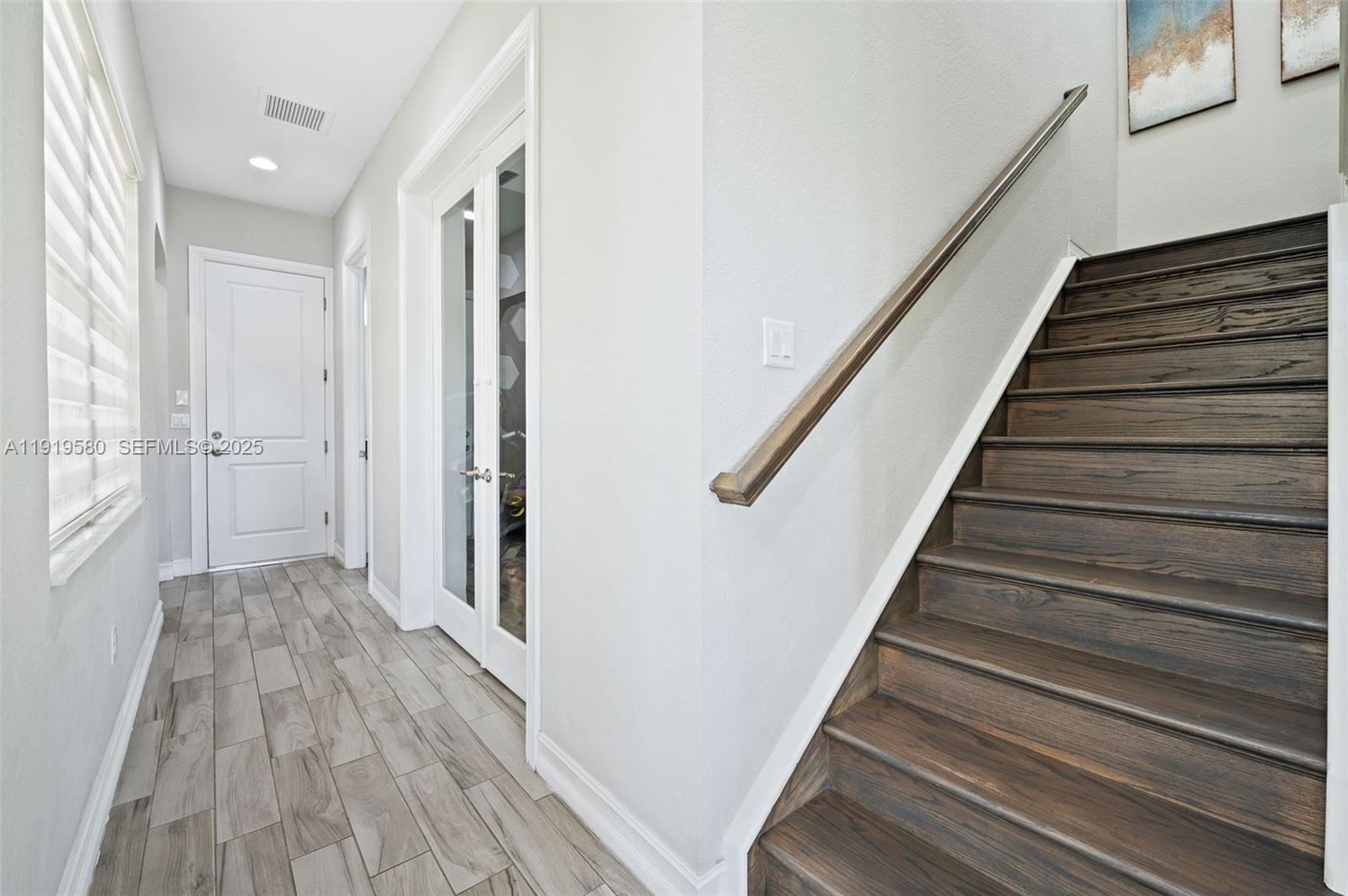 445 Southwest 113th Lane Pembroke Pines, FL 33025 - Photo 9 of 26 a view of a hallway with wooden floor and entryway