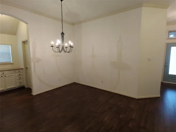 a view of a room with wooden floor and white walls