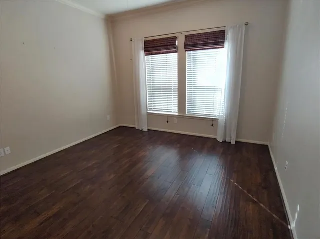 a view of wooden floor and windows in a room
