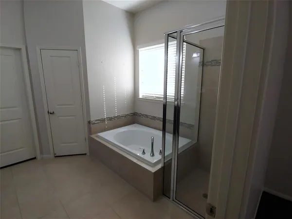 a bathroom with a tub and shower
