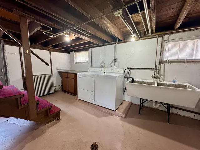 a living room with stainless steel appliances kitchen island granite countertop furniture and a sink
