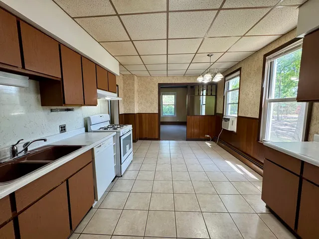 a kitchen with a sink a counter space cabinets and appliances