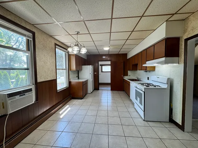 a kitchen with stainless steel appliances granite countertop a stove a sink dishwasher and a refrigerator