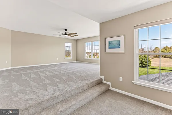 a spacious bedroom with a bed and a window