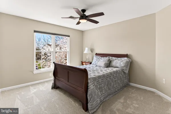 a bed sitting in a bedroom next to a window
