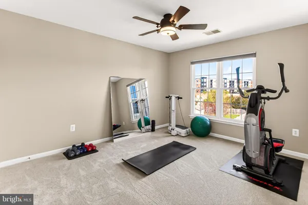 a room with gym equipment and a large window