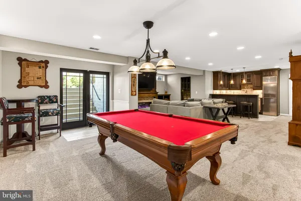 a room with pool table and windows