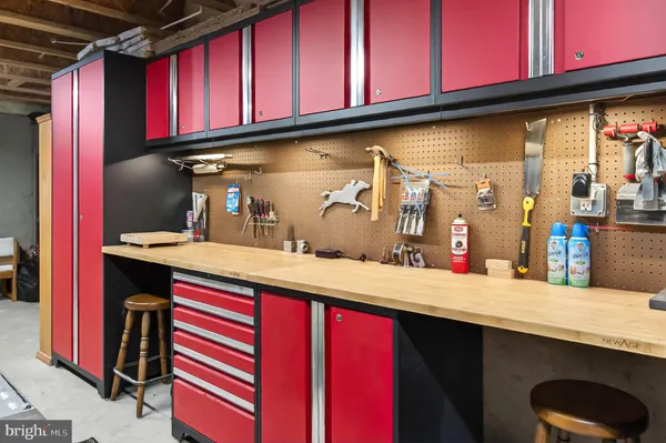 a kitchen with red cabinets a sink and appliances