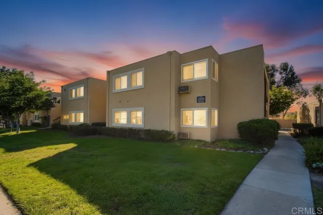 a front view of a house with a garden and yard