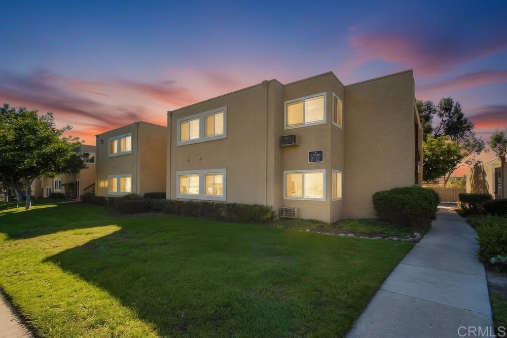 a front view of a house with a garden and yard