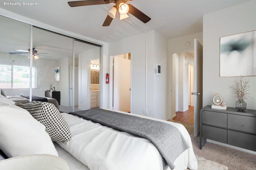 12643 Robison Boulevard, Unit 213 Poway, CA 92064 - Photo 12 of 49 a bedroom with a large bed and a chandelier