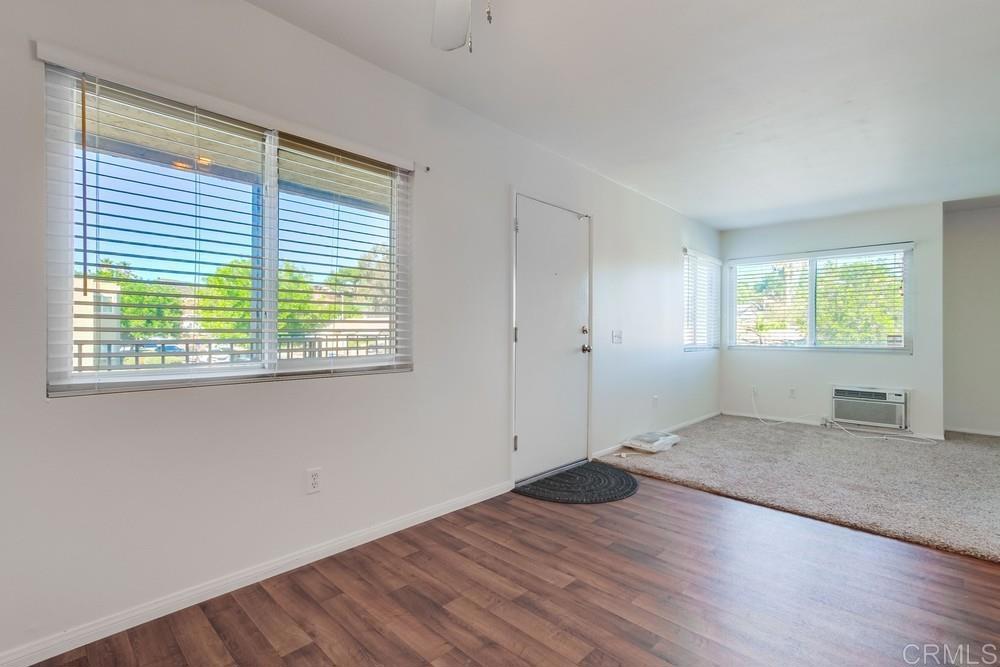 12643 Robison Boulevard, Unit 213 Poway, CA 92064 - Photo 14 of 49 an empty room with wooden floor and windows
