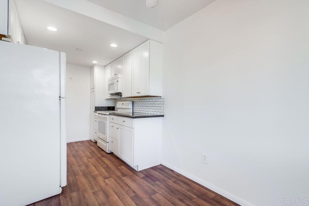 12643 Robison Boulevard, Unit 213 Poway, CA 92064 - Photo 16 of 49 a kitchen with a refrigerator and white cabinets