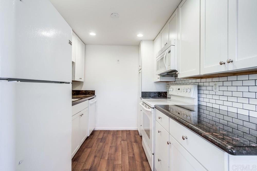 12643 Robison Boulevard, Unit 213 Poway, CA 92064 - Photo 17 of 49 a kitchen with stainless steel appliances granite countertop a sink and cabinets