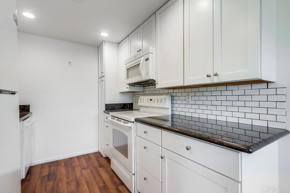 12643 Robison Boulevard, Unit 213 Poway, CA 92064 - Photo 18 of 49 a kitchen with stainless steel appliances a sink dishwasher a stove and white cabinets