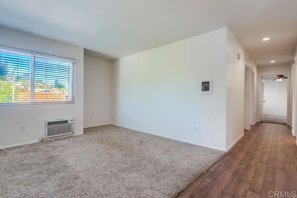 12643 Robison Boulevard, Unit 213 Poway, CA 92064 - Photo 25 of 49 an empty room with wooden floor and windows