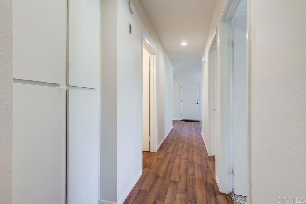 12643 Robison Boulevard, Unit 213 Poway, CA 92064 - Photo 26 of 49 a view of a hallway with wooden floor