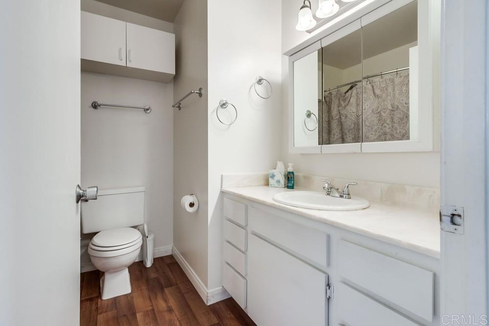 12643 Robison Boulevard, Unit 213 Poway, CA 92064 - Photo 40 of 49 a bathroom with a toilet a sink and mirror