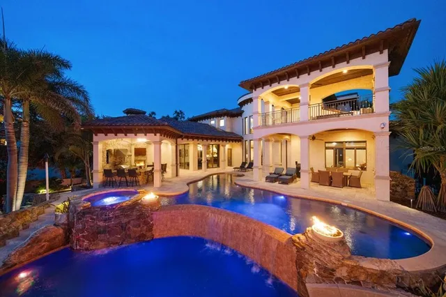a front view of a house with a yard and potted plants