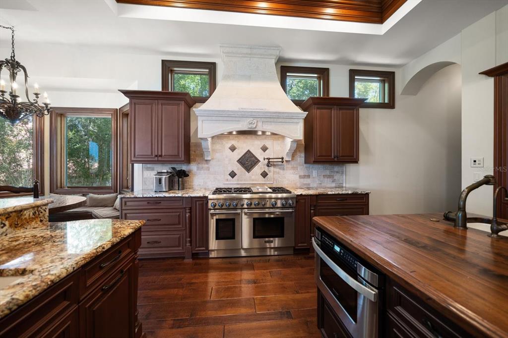 10930 Spring Street Largo, FL 33774 - Photo 19 of 100 a kitchen with stainless steel appliances granite countertop a stove and a sink
