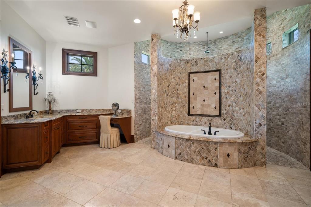 10930 Spring Street Largo, FL 33774 - Photo 26 of 100 a spacious bathroom with a tub sink and mirror