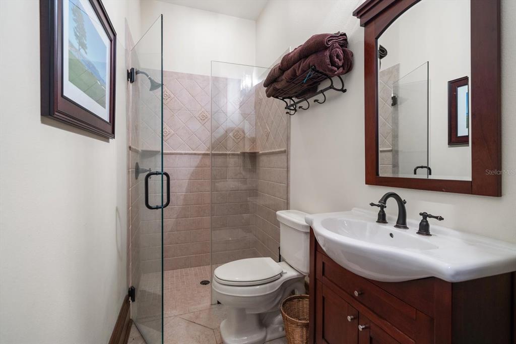 10930 Spring Street Largo, FL 33774 - Photo 30 of 100 a bathroom with a sink a toilet and shower