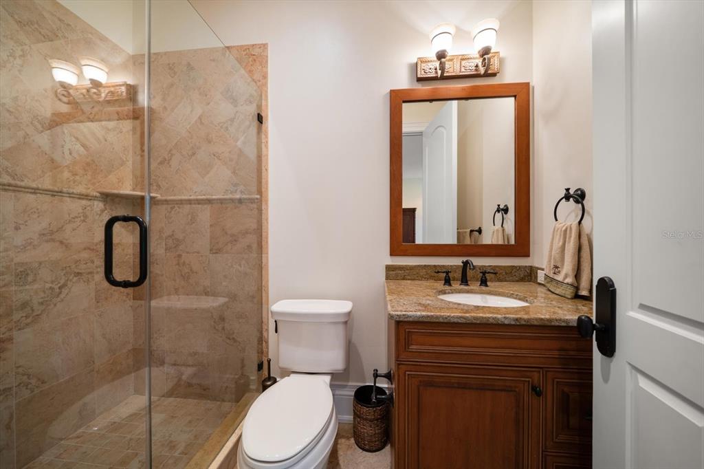 10930 Spring Street Largo, FL 33774 - Photo 34 of 100 a bathroom with a sink a toilet and shower