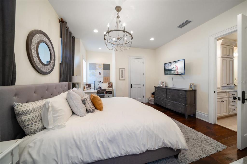 10930 Spring Street Largo, FL 33774 - Photo 37 of 100 a bedroom with a bed and dresser with mirror