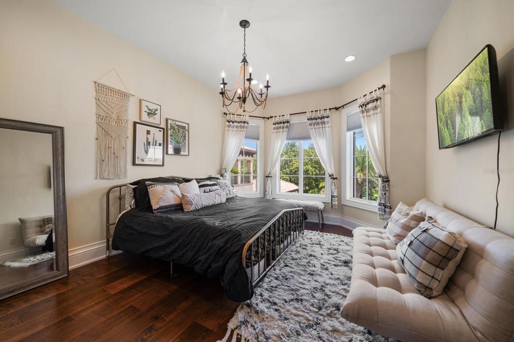 10930 Spring Street Largo, FL 33774 - Photo 39 of 100 a spacious bedroom with a bed and a couch