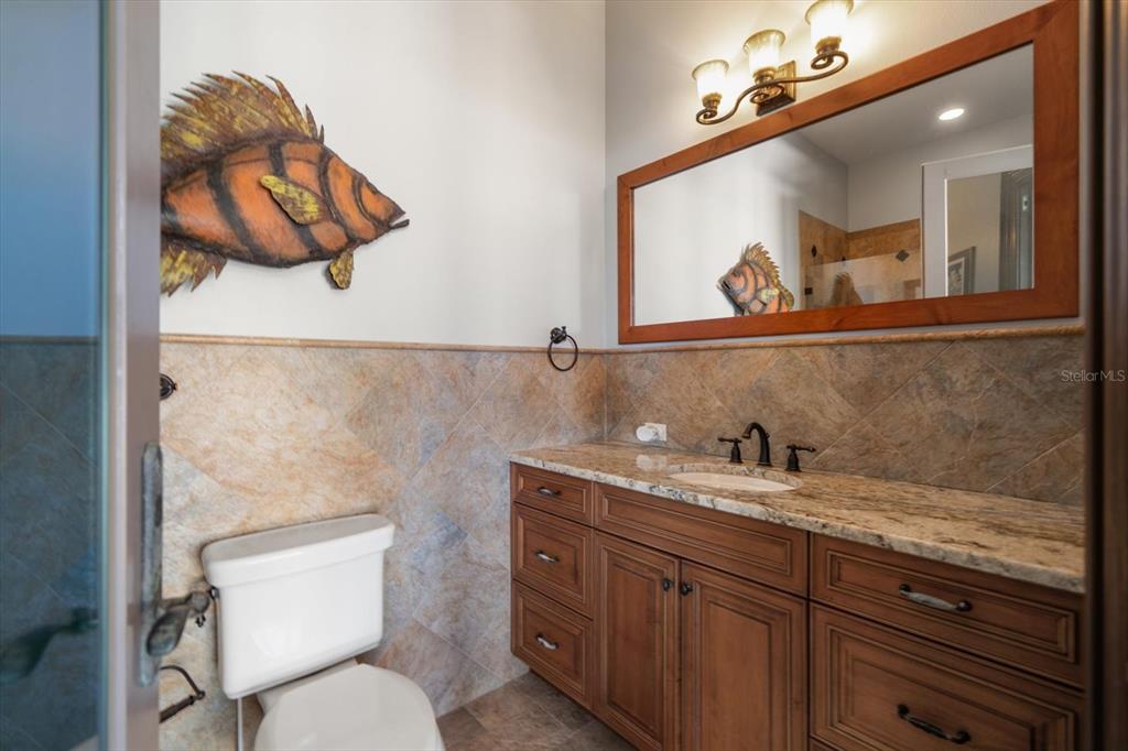 10930 Spring Street Largo, FL 33774 - Photo 49 of 100 a bathroom with a toilet sink and mirror